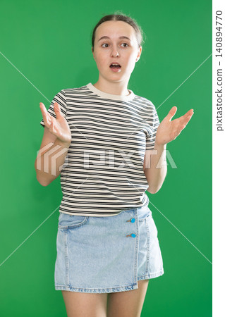 Teenage girl explaining or telling something in front of green screen Teenage girl explaining or telling something in front of green screen 140894770