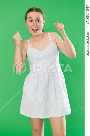 Happy teenage girl in front of green screen Happy teenage girl in front of green screen 140894844