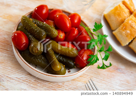 Homemade marinated tomatoes and cucumbers on plate 140894949