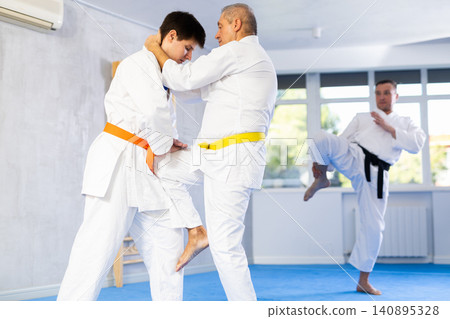 Young and elderly men training judo fight Young and elderly men training judo fight 140895328