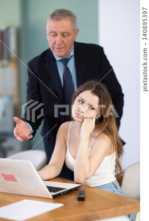 Boss scolding at office employee 140895397