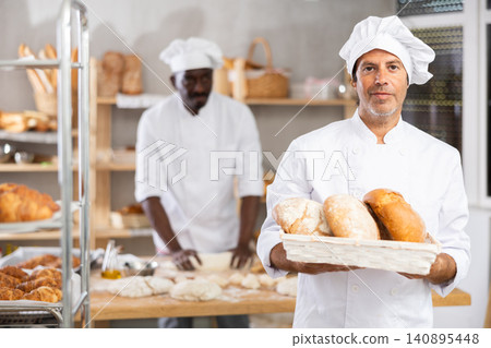 Adult man baker with homemade bread Adult man baker with homemade bread 140895448
