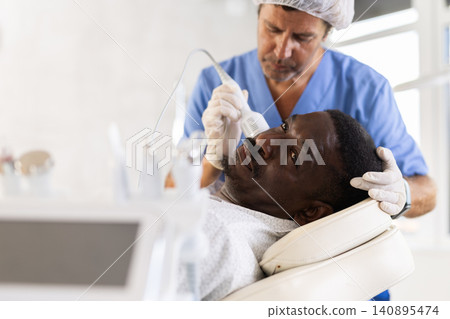 African American undergoing cosmetic facial treatment using cold hammer African American undergoing cosmetic facial treatment using cold hammer 140895474