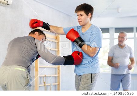 Two men training boxing fight in studio 140895556