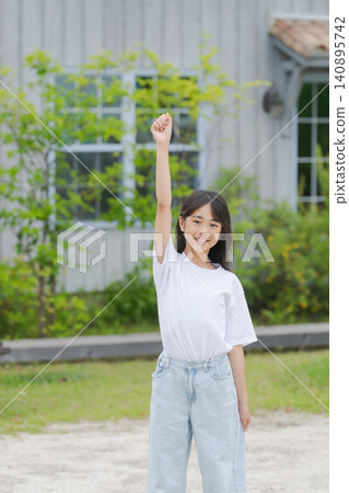 Elementary school student raising fist Elementary school student raising fist 140895742