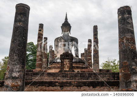 Rear view of old Buddha statue seated in Wat Mahathat temple the most important and impressive temple compound in Sukhothai Historical Park. Rear view of old Buddha statue seated in Wat Mahathat temple the most important and impressive temple compound in Sukhothai Historical Park. 140896000