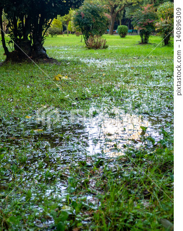 Park after the rain. Park lawn in puddles. After bad weather. Autumn in the park. Park after the rain. Park lawn in puddles. After bad weather. Autumn in the park. 140896309