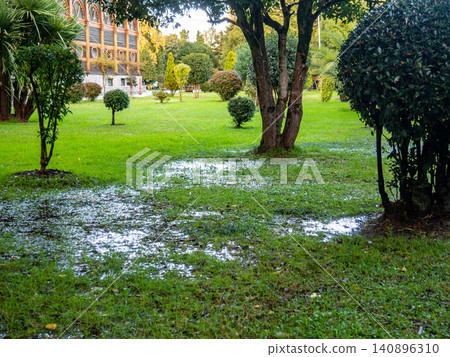 Park after the rain. Park lawn in puddles. After bad weather.  Autumn in the park. 140896310