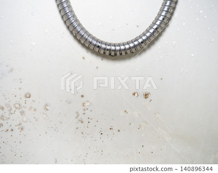 Mold on the surface of the bathroom. Dark mold close-up on bathroom enamel. Dirty white surface. The concept of the appearance of bacteria. Mold on the surface of the bathroom. Dark mold close-up on bathroom enamel. Dirty white surface. The concept of the appearance of bacteria. 140896344