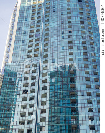 Glass facade of a house under construction with open windows. Windows opening outwards. Geometry in architecture. Glass facade of a house under construction with open windows. Windows opening outwards. Geometry in architecture. 140896364