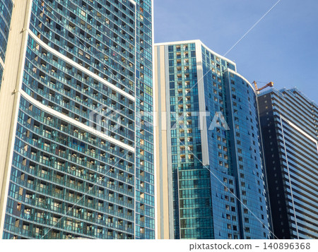 Glass facade of a house under construction with open windows.  Windows opening outwards. Geometry in architecture. 140896368