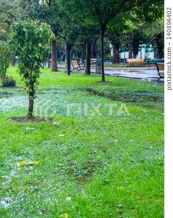 Park after the rain. Park lawn in puddles. After bad weather. Autumn in the park. Park after the rain. Park lawn in puddles. After bad weather. Autumn in the park. 140896402