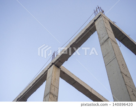 Structure made of concrete piles. Frame of a house under construction. Stone beams. Structure made of concrete piles. Frame of a house under construction. Stone beams. 140896420