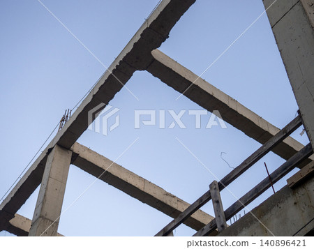 Structure made of concrete piles. Frame of a house under construction. Stone beams. Structure made of concrete piles. Frame of a house under construction. Stone beams. 140896421