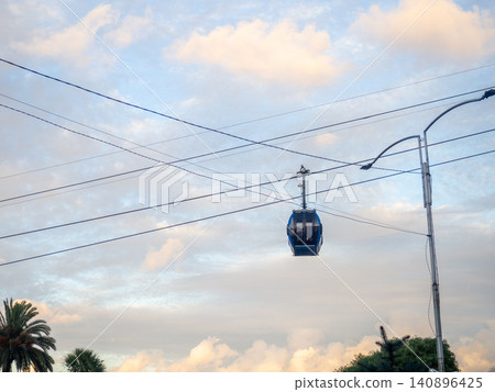 Cabins on a rope. Ropeway. Cabin silhouette. Road in the city on a lift. Cabins on a rope. Ropeway. Cabin silhouette. Road in the city on a lift. 140896425