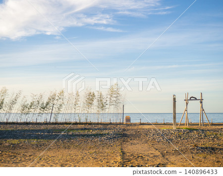 Empty Black Sea beach in the off-season. Autumn at the resort. There are no people on the beach. Empty Black Sea beach in the off-season. Autumn at the resort. There are no people on the beach. 140896433
