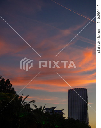 Construction of a multi-storey building against the backdrop of the sunset sky. Construction at the resort. Landscapes of Batumi. A developing place. Construction industry. 140896445