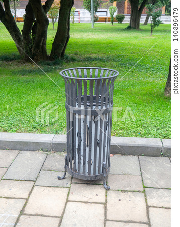 An interesting design trash can in the park. Taking care of cleanliness. Trash. Environment protection. 140896479