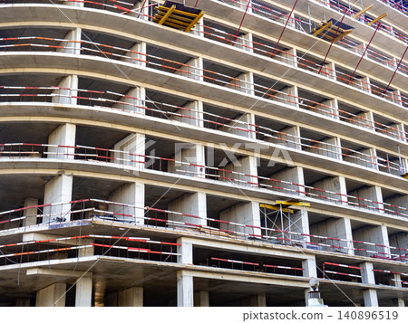 Construction of a modern high-rise building. Sides on the floors. Concrete frame of a building under construction. Construction in progress Construction of a modern high-rise building. Sides on the floors. Concrete frame of a building under construction. Construction in progress 140896519
