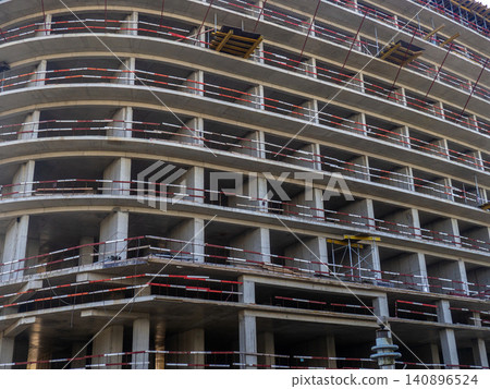 Construction of a modern high-rise building. Sides on the floors. Concrete frame of a building under construction. Construction in progress Construction of a modern high-rise building. Sides on the floors. Concrete frame of a building under construction. Construction in progress 140896524