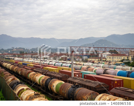 Parking for many trains. Freight trains. Railway station. Industrial zone in the city. View from above. Concept of cargo delivery by train Parking for many trains. Freight trains. Railway station. Industrial zone in the city. View from above. Concept of cargo delivery by train 140896538