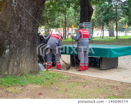 Utility workers. Cleaners at work. Street cleaning workers. Modern working professions. On the street Utility workers. Cleaners at work. Street cleaning workers. Modern working professions. On the street 140896574