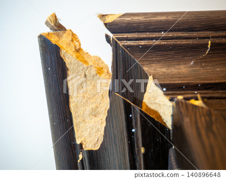 corner of the cabinet is broken. Crack in a wooden cabinet. Breakage when carrying furniture. Needs restoration. corner of the cabinet is broken. Crack in a wooden cabinet. Breakage when carrying furniture. Needs restoration. 140896648