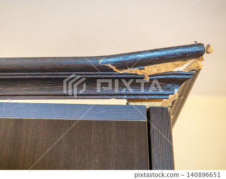 corner of the cabinet is broken. Crack in a wooden cabinet. Breakage when carrying furniture. Needs restoration. corner of the cabinet is broken. Crack in a wooden cabinet. Breakage when carrying furniture. Needs restoration. 140896651