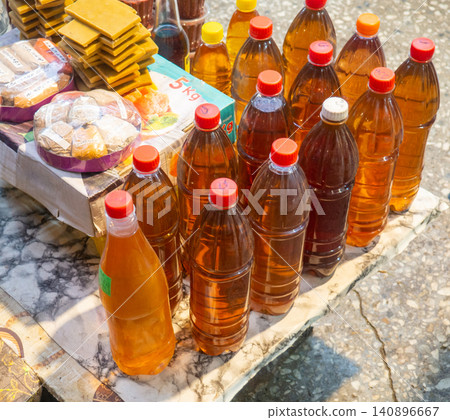 Homemade wines in plastic bottles. Alcohol at the market. Oriental bazaar counter. Homemade wines in plastic bottles. Alcohol at the market. Oriental bazaar counter. 140896667
