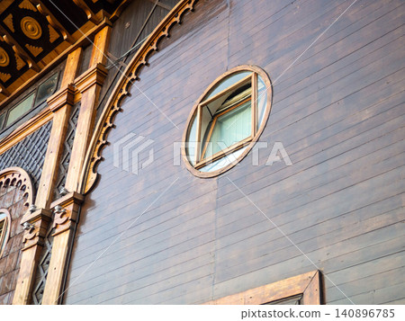 Windows in a wooden theater. Facade of a beautiful building. Georgian theatre. Windows in a wooden theater. Facade of a beautiful building. Georgian theatre. 140896785