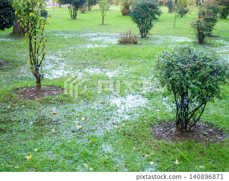 Park after the rain. Park lawn in puddles. After bad weather. Autumn in the park. Park after the rain. Park lawn in puddles. After bad weather. Autumn in the park. 140896871
