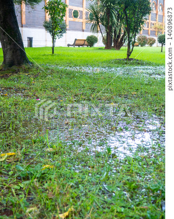 Park after the rain. Park lawn in puddles. After bad weather. Autumn in the park. Park after the rain. Park lawn in puddles. After bad weather. Autumn in the park. 140896873