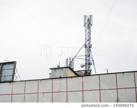 Cell phone tower on the roof of a building. The concept of abundant internet. Antenna for cell phone communication. Cell phone tower on the roof of a building. The concept of abundant internet. Antenna for cell phone communication. 140896878