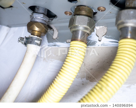 Part of gas equipment. Hoses in a gas water heater. Gas flows through these pipes at home Part of gas equipment. Hoses in a gas water heater. Gas flows through these pipes at home 140896894