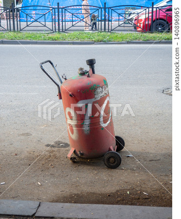 Gas cylinder for refueling cars. Refueling. Gas cylinder in the city. Gas cylinder for refueling cars. Refueling. Gas cylinder in the city. 140896965