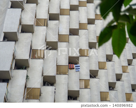 Balconies of unusual shape. Architecture background. Uneven house. High-rise building. Balconies of unusual shape. Architecture background. Uneven house. High-rise building. 140896982