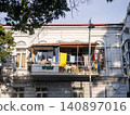 Linen on the old balcony. Life of local residents. Drying clothes. 140897016