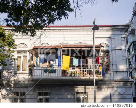 Linen on the old balcony. Life of local residents. Drying clothes. 140897016