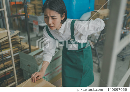A female staff member injured her back in the back room of a supermarket. A female staff member injured her back in the back room of a supermarket. 140897066