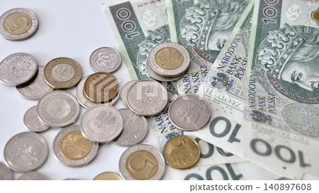 Polish Zloty Banknotes and Coins on White Background Polish Zloty Banknotes and Coins on White Background 140897608