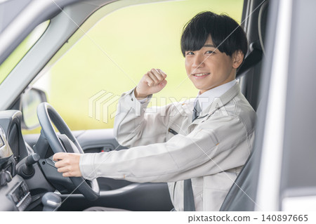 A worker makes a triumphant gesture inside the vehicle. A worker makes a triumphant gesture inside the vehicle. 140897665