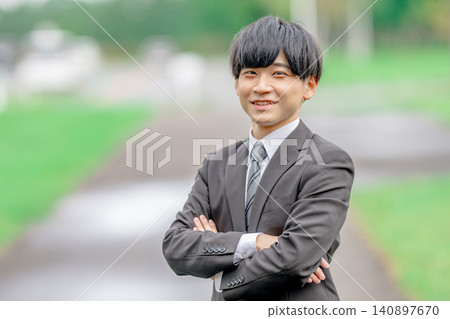 A young businessman with his arms crossed outdoors A young businessman with his arms crossed outdoors 140897670