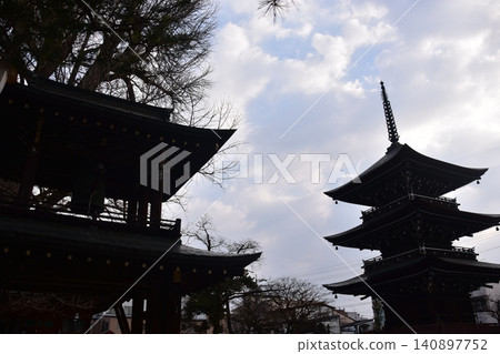 Takayama City, Gifu Prefecture, Japan: The three-story pagoda and bell tower gate of Hida Kokubunji Temple and the surrounding townscape, as seen during the spring Takayama Festival. Takayama City, Gifu Prefecture, Japan: The three-story pagoda and bell tower gate of Hida Kokubunji Temple and the surrounding townscape, as seen during the spring Takayama Festival. 140897752