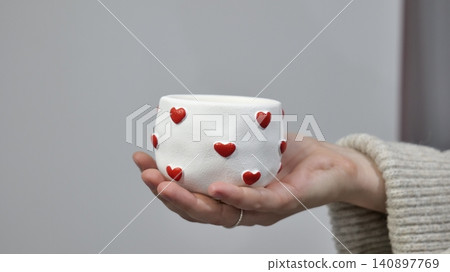 Handmade soy wax candle with wooden wick in white gypsum holder decorated with red hearts 140897769