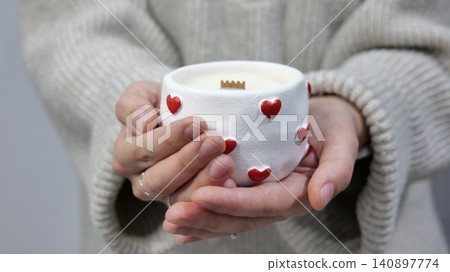 Handmade soy wax candle with wooden wick in white gypsum holder decorated with red hearts 140897774