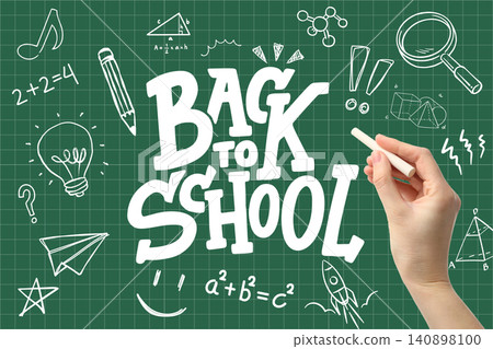 Hand writes back to school on chalkboard filled with drawings and educational symbols Hand writes back to school on chalkboard filled with drawings and educational symbols 140898100