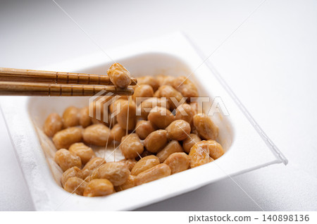 Sticky natto picked up with chopsticks Sticky natto picked up with chopsticks 140898136