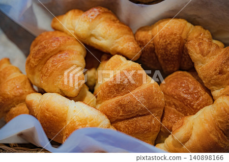 Freshly baked croissants in a basket Freshly baked croissants in a basket 140898166