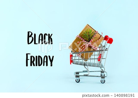 Black friday shopping cart with gifts on pastel background 140898191