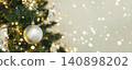 Christmas tree with silver ornament hanging in the outdoors 140898202